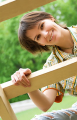 Young woman on a wooden ladder.