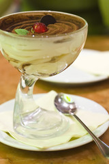 Delicate tiramisu dessert with cherry