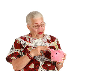 Retired woman holkding piggy bank 