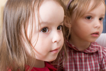 Portrait of two sisters looking at mother