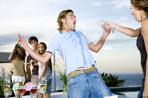 woman-throwing-her-drink-over-a-man-at-a-party-stock-photo-and