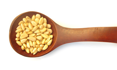 Pine nuts edible seeds in wooden spoon