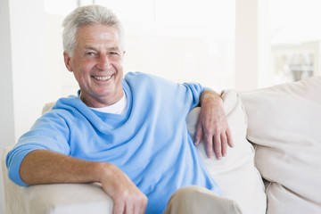 Man sitting in living room smiling