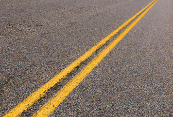 yellow dividing lines on the highway.