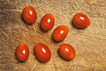Fresh cherry tomatoes on cutting kitchen board.