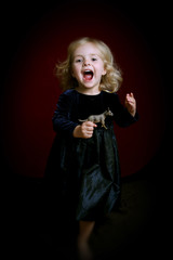 happy little girl in party dress with toy