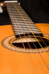 Classical guitar close up on dark