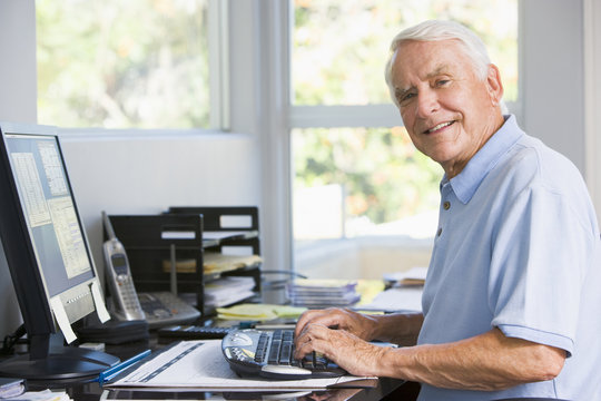 Man in home office using computer