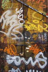 Old wooden door covered in graffiti