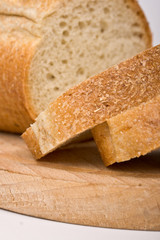 Sliced bread on wooden plate