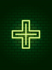 Neon pharmacy cross against wall