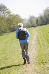 Fototapeta premium Man walking outdoors with people in background