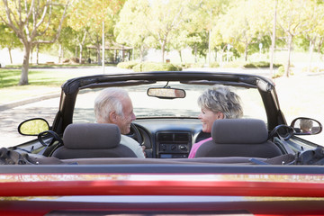 Couple in convertible car smiling