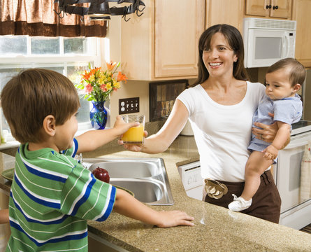 Mom And Children In Kitchen.