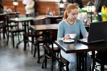 girl with computer in cafe