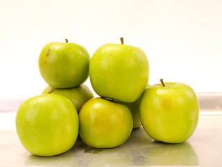 Green Apples Stacked on Steel Oven Tray