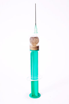 syringe filled witf euro cents