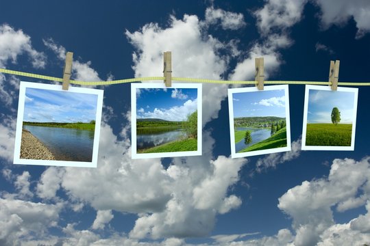Landscape photographs hanging on a clothesline 