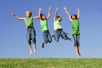group of happy smiling summer children jumping