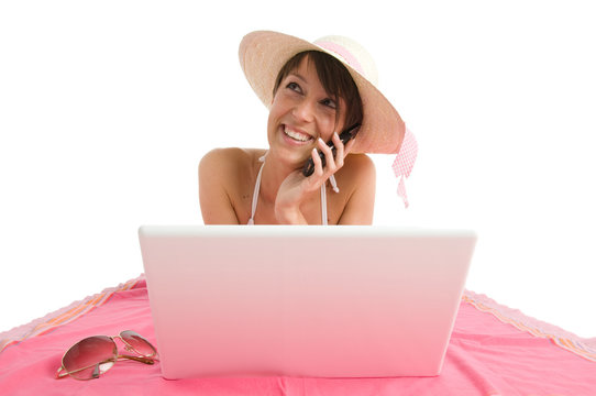 Young woman in bikini with laptop, working and mobile speking
