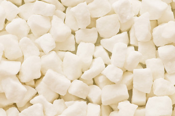 White sugar cubes arranged at the background