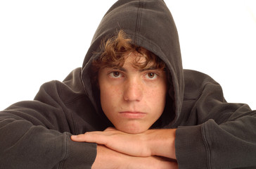 attractive confident teenage boy with black hoodie over head