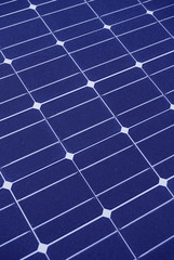 Blue solar panels making green energy in sunlight