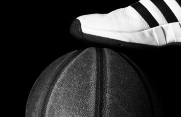 basketball shoe and ball, on black background