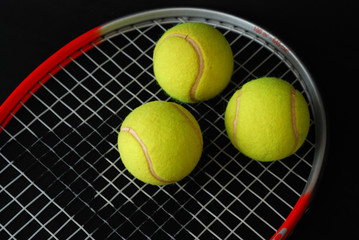 tennis racket and three balls