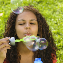 Girl blows bubbles