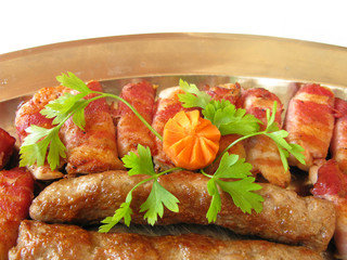 Meat kebab and rolled chicken with bacon broiled on a grill 