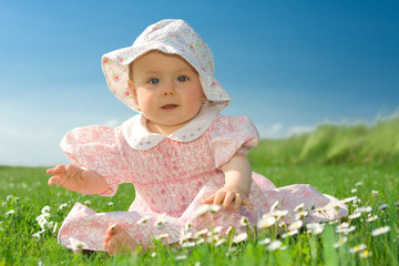 Baby girl sat in flowery field