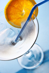 Glass of cocktail with ice and orange slice
