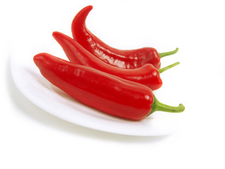 Tasty red peppers on white plate