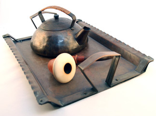Tea Pot And Pipe On A Vintage antique Tray