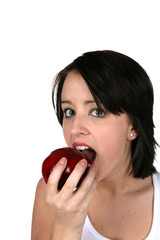 Young woman biting red apple