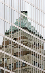 Historic Art Deco Building Reflects in Glass of Skyscraper