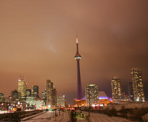 Fototapeta na wymiar Toronto CN tower glowing and shining city night sky