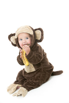 Baby In Monkey Costume Holding Banana