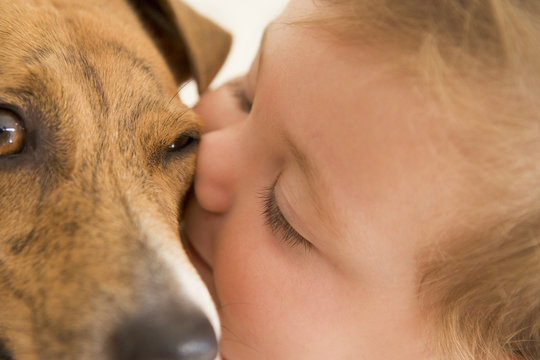 Baby Kissing Dog