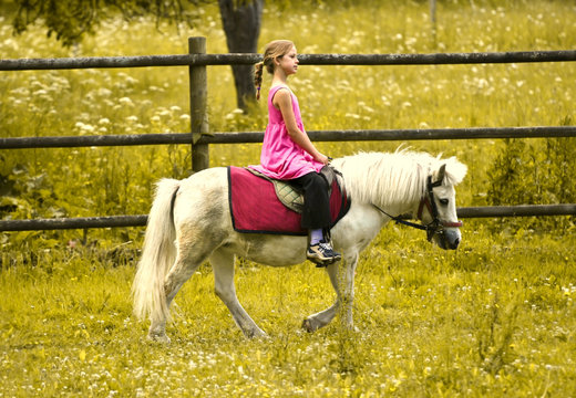 Young Girl Riding Pony