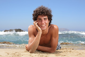Fototapeta na wymiar happy young man on the beach
