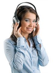Fototapeta premium Young girl listens to music on a white background