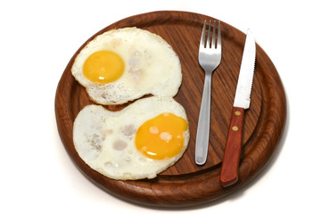 served fried egg on wooden plate