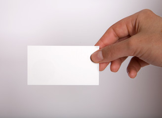 Female hand holding blank card.