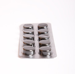 black pills on white background