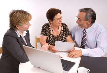 Mature couple talking to financial planner - obrazy, fototapety, plakaty