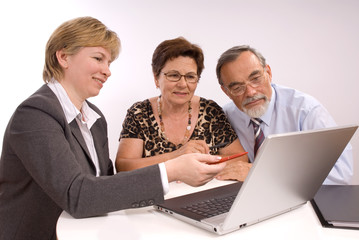 Mature couple talking to financial planner