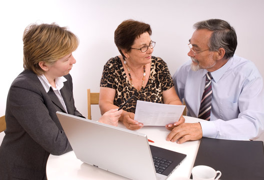 Mature Couple Talking To Financial Planner