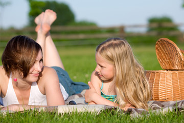 Mother and daughter having a  picnic